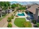 Aerial view showcasing a private backyard with a sparkling pool, manicured lawn, and outdoor kitchen area at 8654 W Melinda Ln, Peoria, AZ 85382