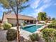 Inviting backyard oasis with a sparkling pool, mature landscaping, a built in grill and an umbrella covered seating area at 8654 W Melinda Ln, Peoria, AZ 85382