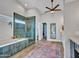 A luxurious bathroom boasts a soaking tub and a separate glass enclosed shower at 8654 W Melinda Ln, Peoria, AZ 85382