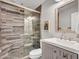 Updated bathroom features a tiled shower with glass door and a modern vanity at 8654 W Melinda Ln, Peoria, AZ 85382