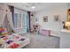 Bright bedroom with a window dressed in shutters, whimsical decor and a fun color palette at 8654 W Melinda Ln, Peoria, AZ 85382