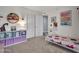 Charming bedroom features a white-metal bed frame, an open closet, and plenty of natural light at 8654 W Melinda Ln, Peoria, AZ 85382