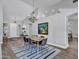 Dining area with table set for four, modern chandelier, and artistic wall decor at 8654 W Melinda Ln, Peoria, AZ 85382