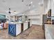 Spacious open concept kitchen with a blue island, wine fridge, stainless appliances, and hardwood floors at 8654 W Melinda Ln, Peoria, AZ 85382