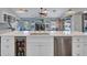 Kitchen island boasts a beverage cooler, stainless dishwasher, modern faucet and quartz countertop at 8654 W Melinda Ln, Peoria, AZ 85382