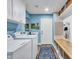 Laundry room with blue walls, white cabinetry, and a convenient folding counter at 8654 W Melinda Ln, Peoria, AZ 85382