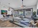 Bright living room with a sectional sofa, stylish decor, and backyard views at 8654 W Melinda Ln, Peoria, AZ 85382