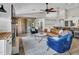 Spacious living room features a modern fireplace, comfortable seating, and access to the kitchen at 8654 W Melinda Ln, Peoria, AZ 85382