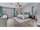 Spacious main bedroom with a ceiling fan, plantation shutters, and elegant furnishings at 8654 W Melinda Ln, Peoria, AZ 85382