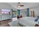 Bright bedroom with vaulted ceiling, backyard view, and light wood-look floors at 8654 W Melinda Ln, Peoria, AZ 85382