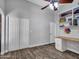 Office with wood-look floors, built-in desk, and closet space at 8654 W Melinda Ln, Peoria, AZ 85382