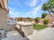 Backyard kitchen with built-in grill, countertop, and manicured lawn for outdoor dining and entertainment at 8654 W Melinda Ln, Peoria, AZ 85382