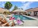 Inviting backyard pool and lounge area, perfect for relaxation and entertainment on a sunny day at 8654 W Melinda Ln, Peoria, AZ 85382