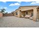 Covered patio with lounge furniture in a gravel backyard, providing an ideal outdoor space for relaxation at 951 E Jacob St, Chandler, AZ 85225