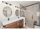 Modern bathroom with dual sinks, quartz countertops, and glass-enclosed shower at 951 E Jacob St, Chandler, AZ 85225