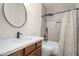 Bathroom with a sleek vanity, updated tiling, and a shower-tub combo at 951 E Jacob St, Chandler, AZ 85225