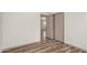 Bedroom featuring neutral walls, wood-look floors, and a closet with sliding doors at 951 E Jacob St, Chandler, AZ 85225