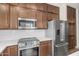 Modern kitchen featuring stainless steel appliances, dark wood cabinetry, and white countertops at 951 E Jacob St, Chandler, AZ 85225