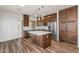 Open kitchen with a large island, stainless steel appliances, and wood-style flooring at 951 E Jacob St, Chandler, AZ 85225