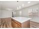 Modern kitchen island featuring white countertops, wood cabinets, and stylish pendant lighting at 951 E Jacob St, Chandler, AZ 85225