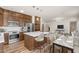 Eat-in kitchen featuring stainless steel appliances, an island with barstool seating and wood-look flooring at 951 E Jacob St, Chandler, AZ 85225