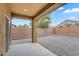 Covered patio with gravel, block wall fence, and stucco support column at 951 E Jacob St, Chandler, AZ 85225