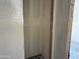 A walk in closet with primed walls and ceiling and a gray concrete floor with a two by four wood board used as a corner support at 9540 W Parkway Dr, Tolleson, AZ 85353