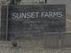 Monument sign made of stone, identifying the community as Sunset Farms at 9540 W Parkway Dr, Tolleson, AZ 85353