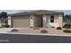 Charming single story home with neutral stucco, rock landscaping, and a two-car garage at 9540 W Parkway Dr, Tolleson, AZ 85353
