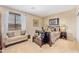 Inviting bedroom with comfortable seating and a window with white curtains at 10804 N 146Th Ave, Surprise, AZ 85379
