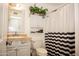Cozy bathroom with toilet, sink vanity, decorative cabinet and a patterned shower curtain at 1108 S Lebanon Ln, Tempe, AZ 85288
