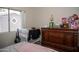 A cozy bedroom featuring natural light and classic wood furnishings at 1108 S Lebanon Ln, Tempe, AZ 85288