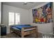A basic bedroom featuring a rustic wood frame bed with natural light at 1108 S Lebanon Ln, Tempe, AZ 85288