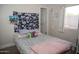 A comfortable bedroom with natural light and unique wall decor at 1108 S Lebanon Ln, Tempe, AZ 85288