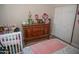A charming bedroom featuring natural light, wood furnishings and a crib at 1108 S Lebanon Ln, Tempe, AZ 85288