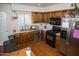 An efficient kitchen features wood cabinets, stainless appliances and white subway tile at 1108 S Lebanon Ln, Tempe, AZ 85288