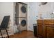 A closet laundry area with stackable washer and dryer and white subway tile at 1108 S Lebanon Ln, Tempe, AZ 85288