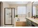 Bathroom featuring a soaking tub, walk-in shower with bronze fixtures and a granite vanity at 12062 W Duane Ln, Peoria, AZ 85383