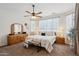 Bright bedroom featuring a ceiling fan, neutral walls, and traditional wood furniture at 12062 W Duane Ln, Peoria, AZ 85383