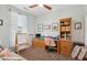 Cozy secondary bedroom featuring a desk, shelving, and a comfortable workspace for work or study at 12062 W Duane Ln, Peoria, AZ 85383