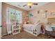 Bright bedroom with a large window, playful decor, white furnishings and a ceiling fan at 12062 W Duane Ln, Peoria, AZ 85383