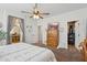Bedroom featuring a ceiling fan, TV, with access to the bathroom and walk-in closet at 12062 W Duane Ln, Peoria, AZ 85383