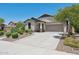 Charming single-story home with a well-maintained front yard and a spacious driveway leading to a two-car garage at 12062 W Duane Ln, Peoria, AZ 85383