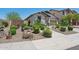 Attractive single-story home with a desert landscape, stone mulch, and a variety of cactus and shrubbery at 12062 W Duane Ln, Peoria, AZ 85383