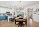 Bright eat-in kitchen features an island with bar stools, a round dining table, and stainless steel appliances at 12062 W Duane Ln, Peoria, AZ 85383