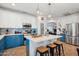 Spacious kitchen with an island, blue and white cabinets, stainless steel appliances, and tiled flooring at 12062 W Duane Ln, Peoria, AZ 85383