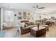 Comfortable living room with a plush sectional sofa, lots of art, and an open connection to the kitchen at 12062 W Duane Ln, Peoria, AZ 85383