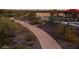 Aerial view of a walking path winding through a desert landscape, perfect for an evening stroll or jog at 12062 W Duane Ln, Peoria, AZ 85383