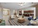 Bright living room featuring an open floor plan, ceiling fan, contemporary furnishings, and tile floors at 19351 E Apricot Ln, Queen Creek, AZ 85142