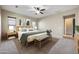 Comfortable main bedroom with ceiling fan, neutral walls, and a stylishly decorated, plush bed at 19351 E Apricot Ln, Queen Creek, AZ 85142
